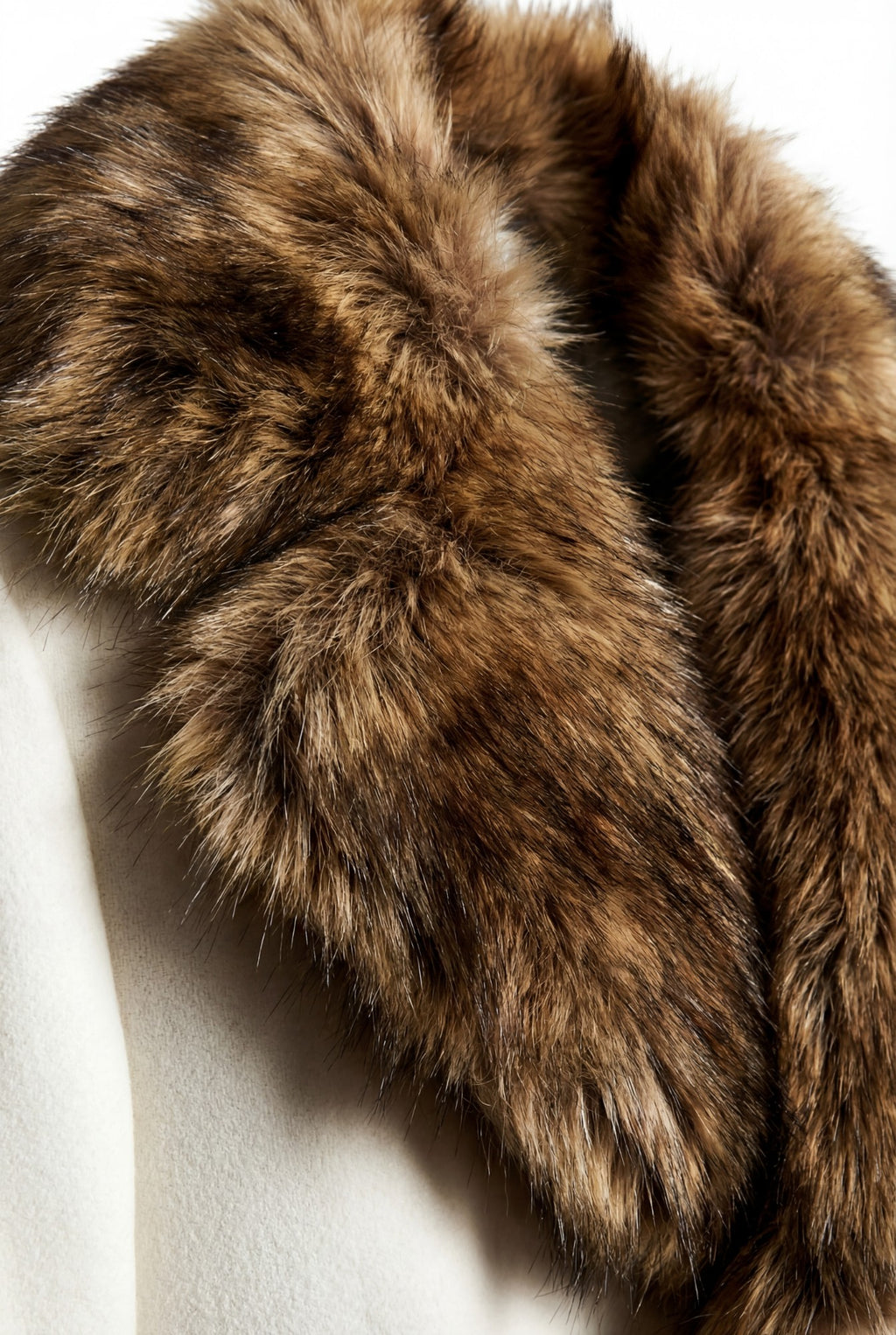 Ivory wool blend coat detail with a brown faux fur collar. Luxury outerwear.